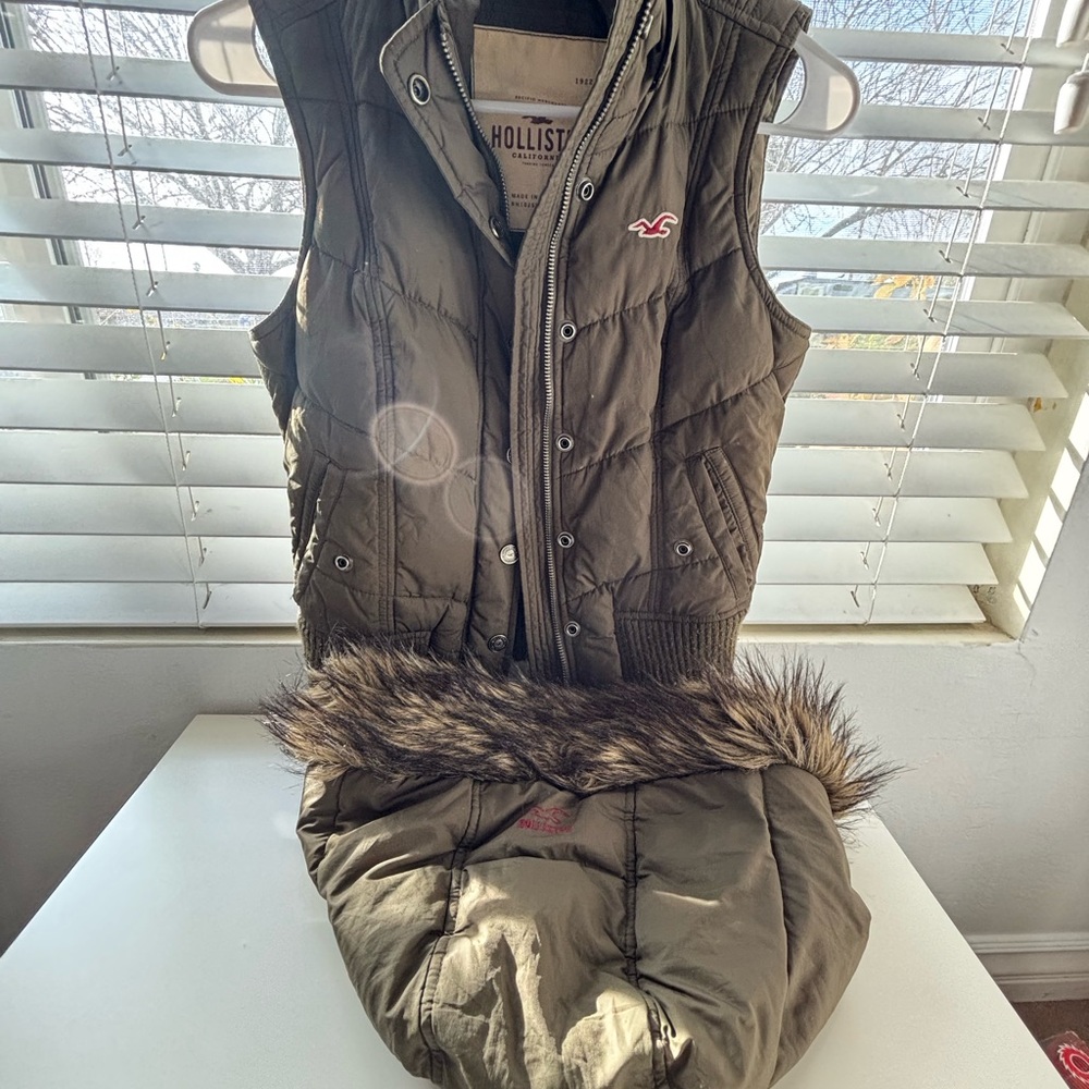 A green vest with a hoodie on it